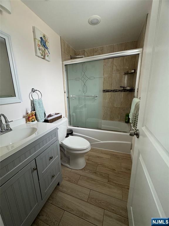 17 Elm Street Ridgefield Park, NJ 07660 - Photo 11 of 15 a bathroom with a granite countertop sink mirror vanity and toilet