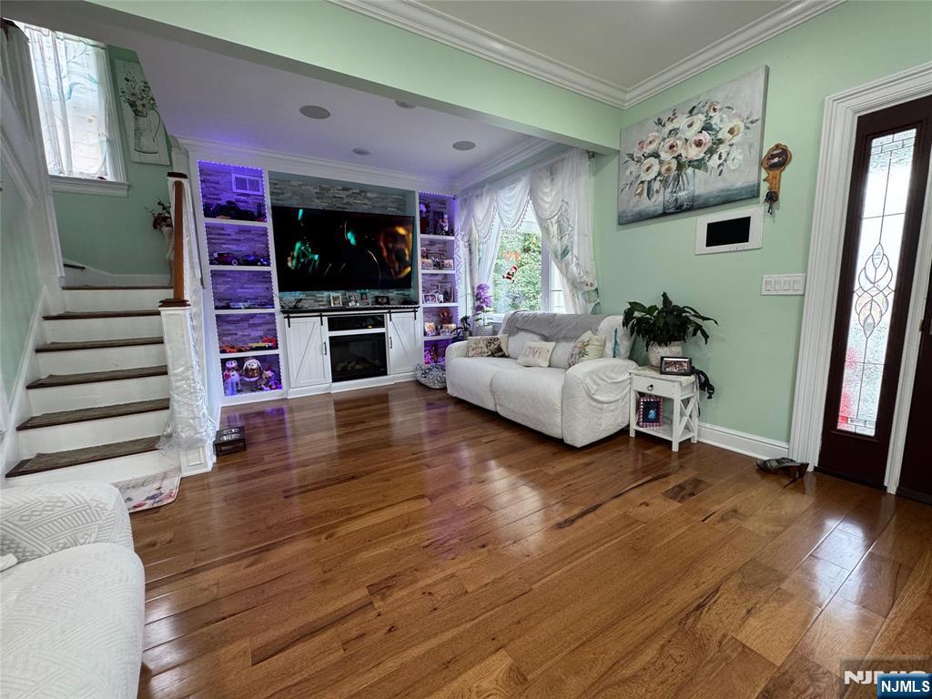 17 Elm Street Ridgefield Park, NJ 07660 - Photo 2 of 15 a living room with furniture a flat screen tv and a fireplace