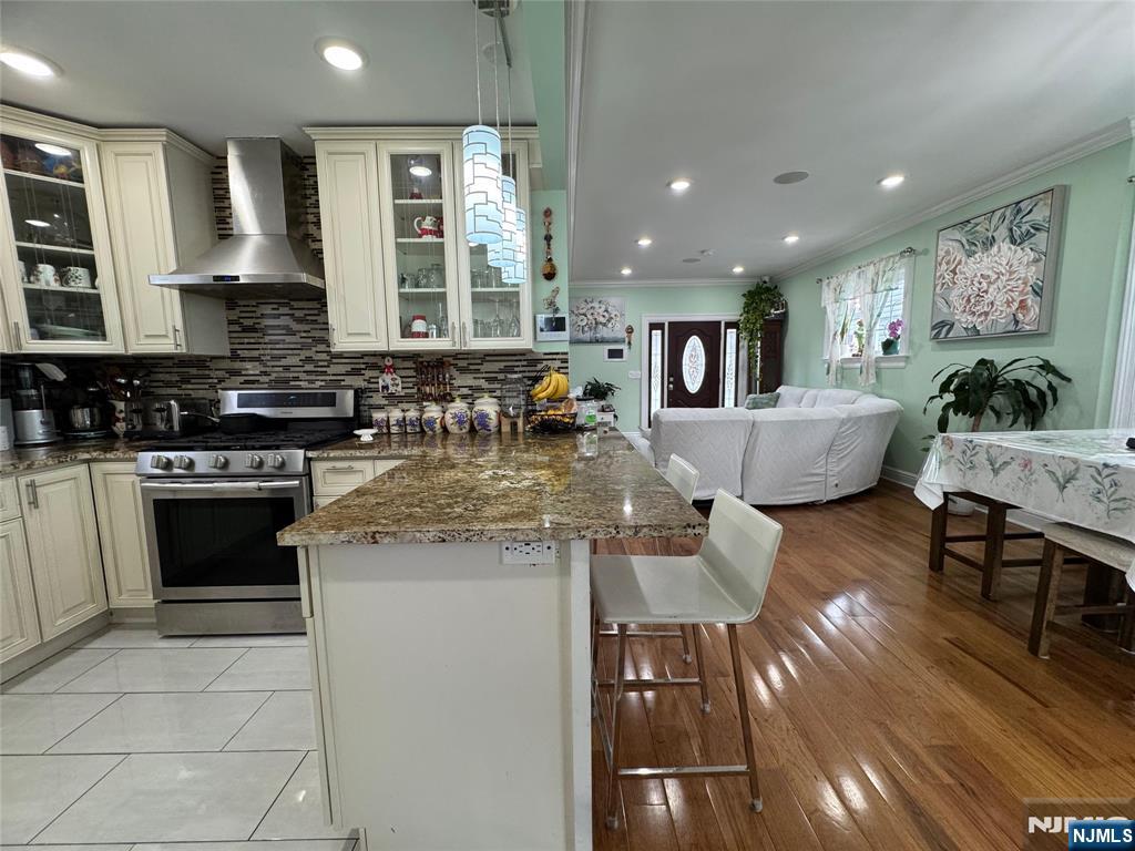 17 Elm Street Ridgefield Park, NJ 07660 - Photo 4 of 15 a kitchen with stainless steel appliances granite countertop a stove and cabinets