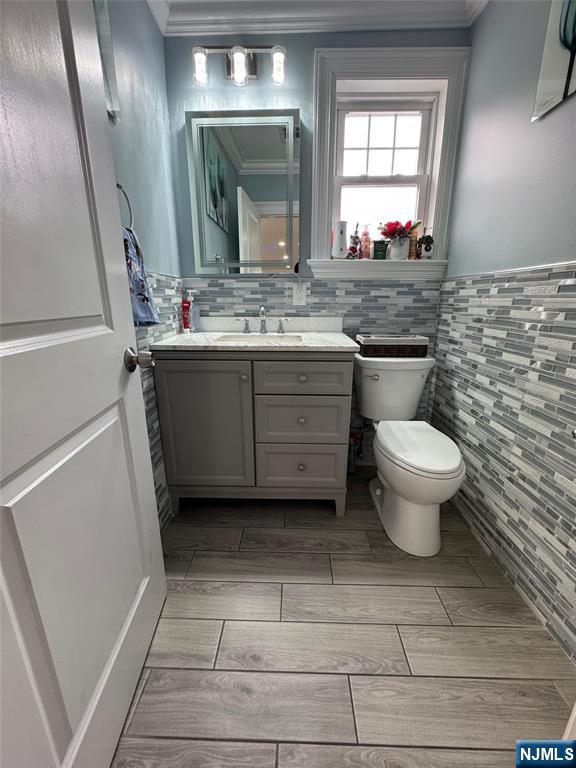 17 Elm Street Ridgefield Park, NJ 07660 - Photo 5 of 15 a bathroom with a toilet sink and mirror