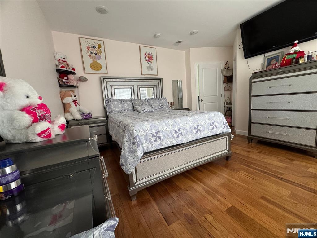 17 Elm Street Ridgefield Park, NJ 07660 - Photo 9 of 15 a bedroom with a bed and wooden floor