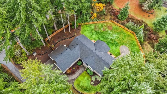 an aerial view of house with yard swimming pool and outdoor seating