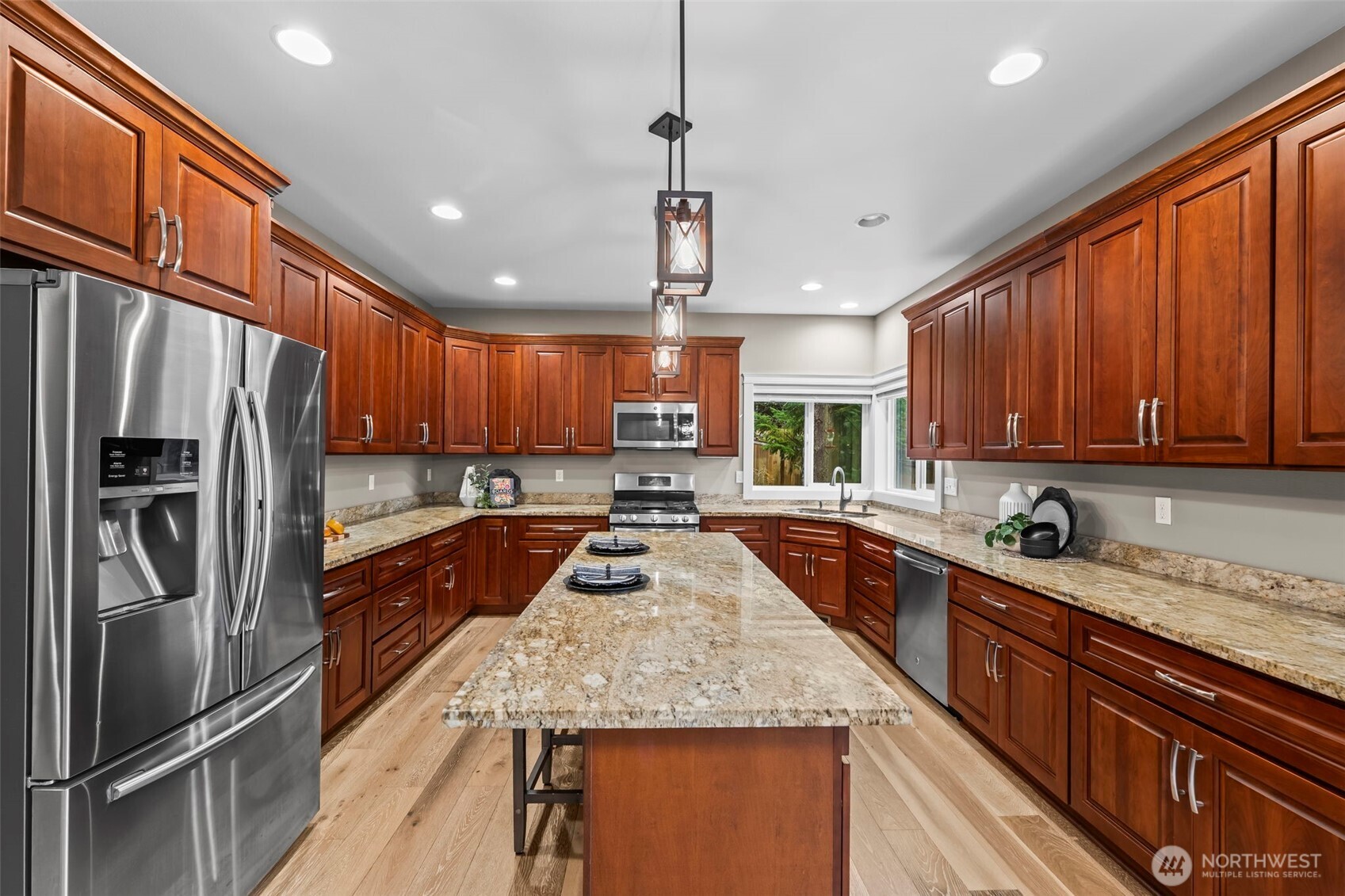 14892 Peacock Hill Road Southeast Olalla, WA 98359 - Photo 13 of 40 a kitchen with stainless steel appliances granite countertop a sink refrigerator and cabinets