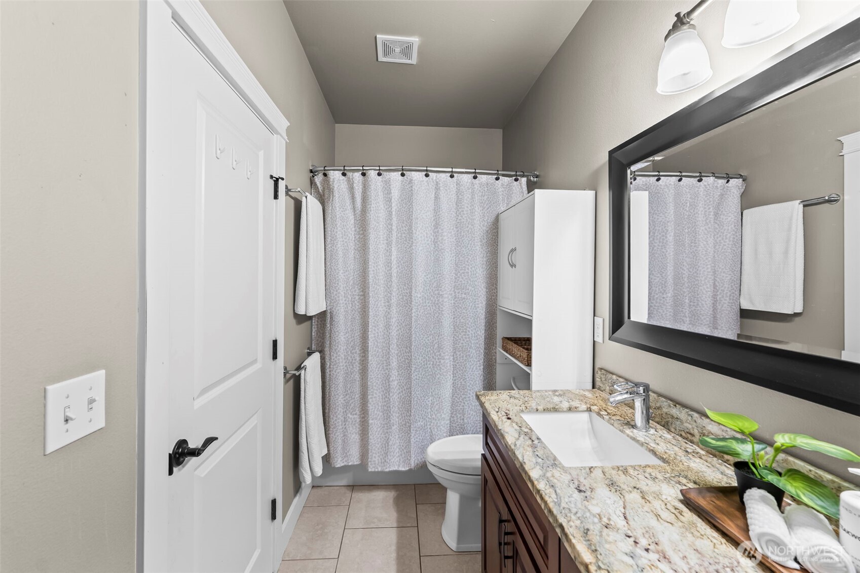 14892 Peacock Hill Road Southeast Olalla, WA 98359 - Photo 18 of 40 a bathroom with a granite countertop double vanity sink a mirror and a shower