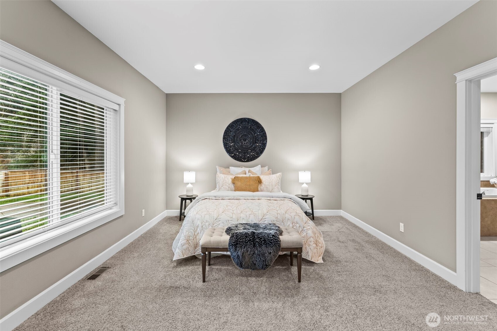 14892 Peacock Hill Road Southeast Olalla, WA 98359 - Photo 20 of 40 a bed sitting in a bedroom next to a window and a larger window