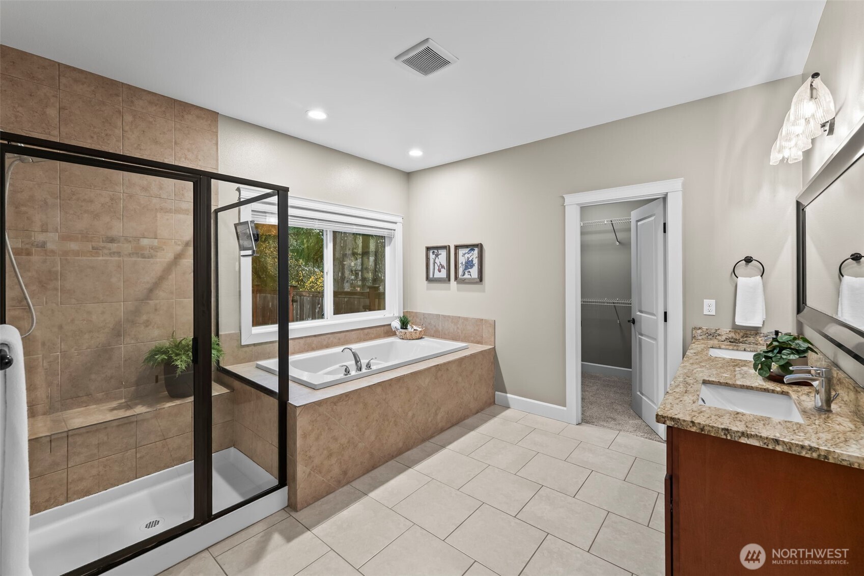 14892 Peacock Hill Road Southeast Olalla, WA 98359 - Photo 24 of 40 a spacious bathroom with a granite countertop tub sink and mirror