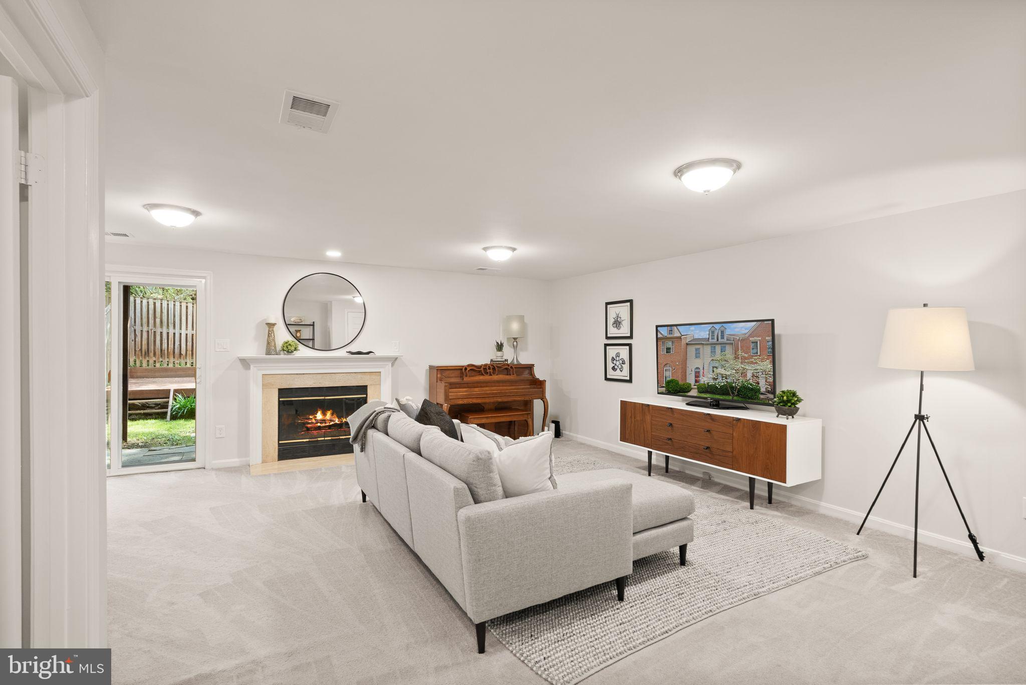 6369 English Ivy Way Springfield, VA 22152 - Photo 22 of 62 a living room with furniture a fireplace and a flat screen tv