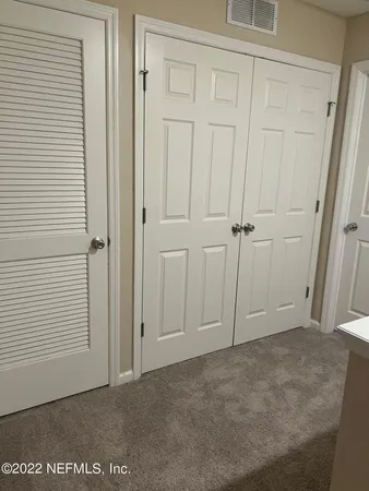 an empty room with a wooden door