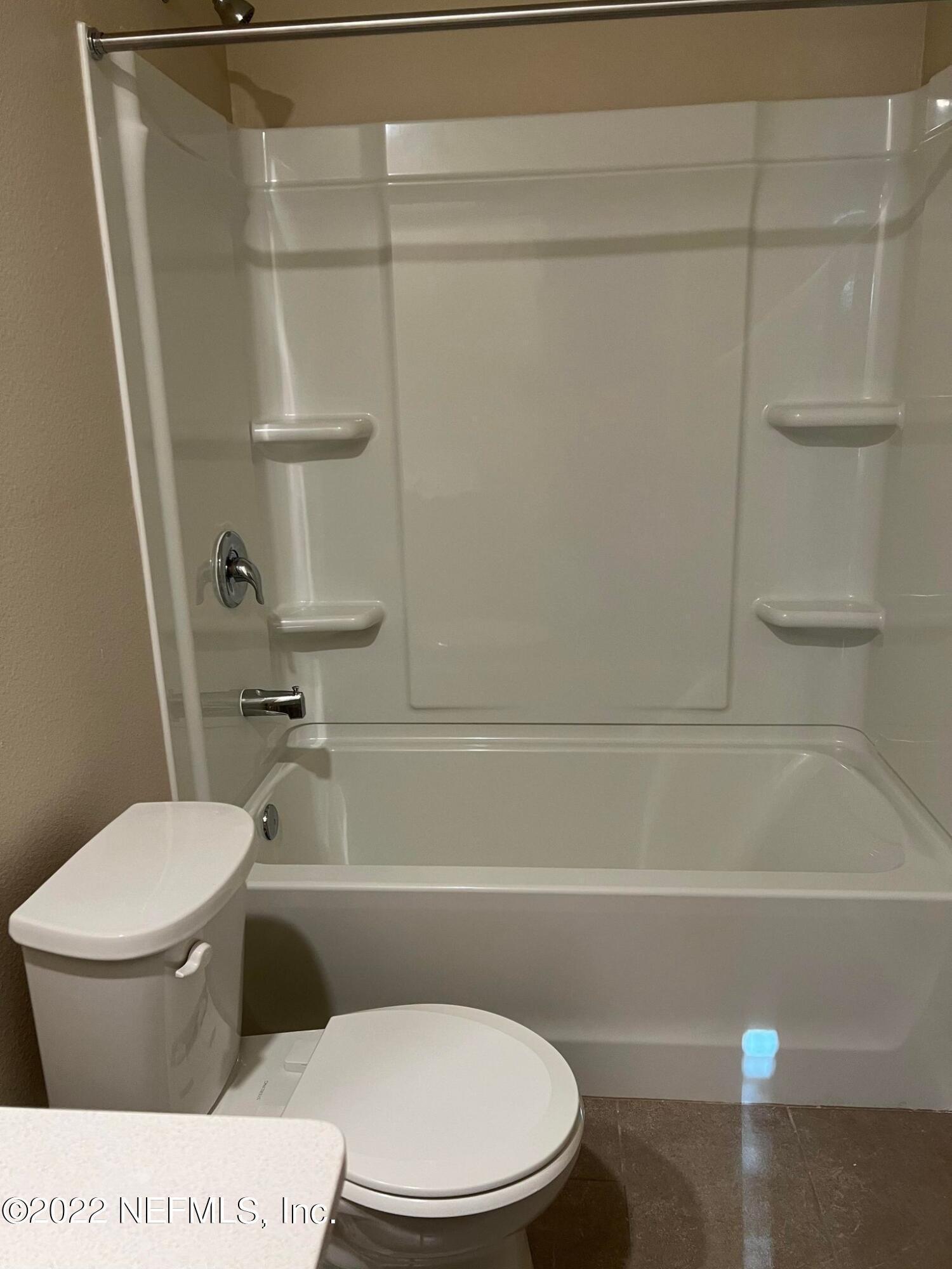 11795 Junegrass Road Jacksonville, FL 32258 - Photo 13 of 15 a bathroom with a toilet and a shower