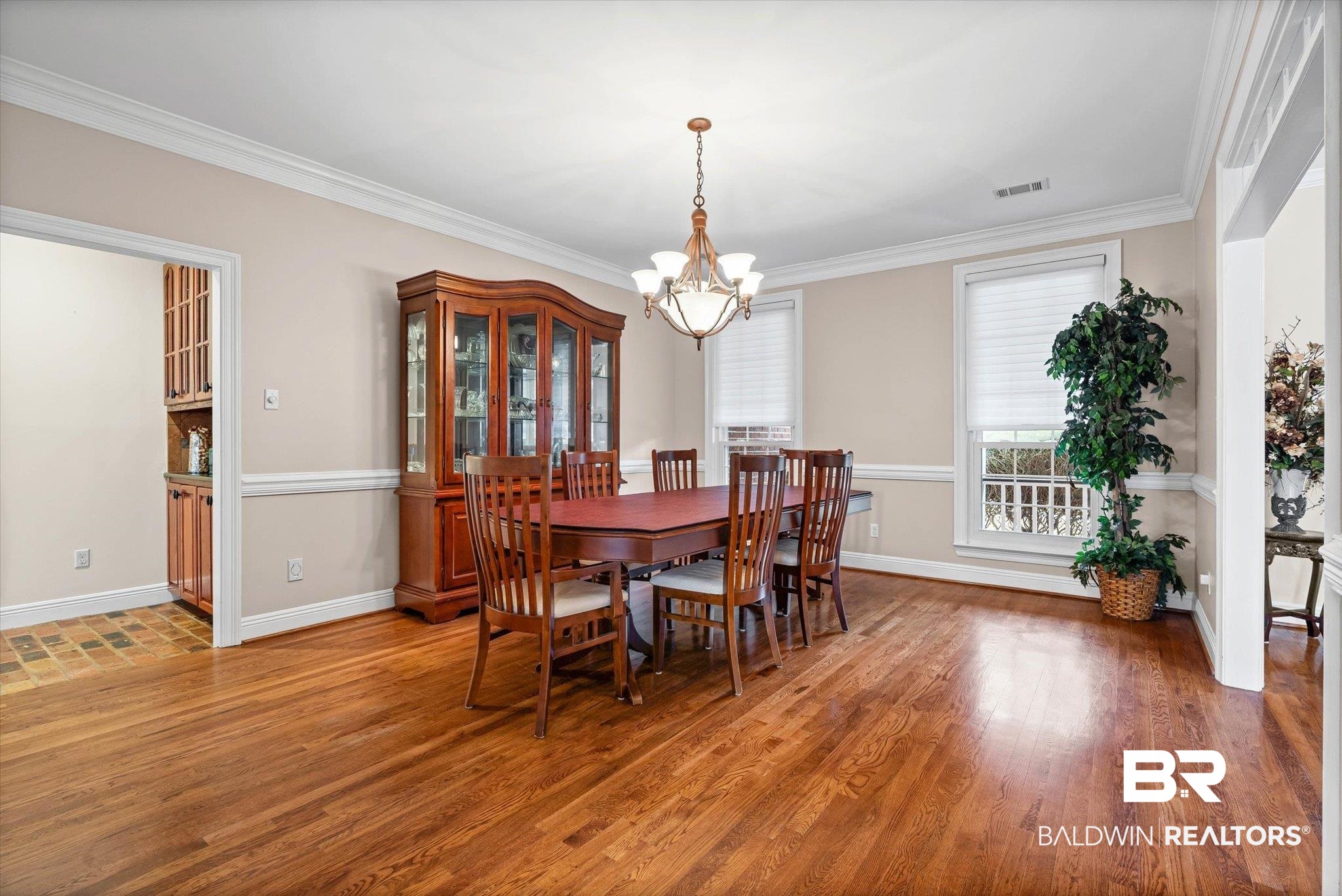 4851 Audubon Drive Mobile, AL 36619 - Photo 7 of 46 Dining space with light wood-type flooring, a chandelier, and ornamental molding