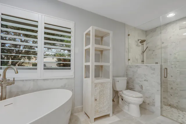 a spacious bedroom with a bed and a window