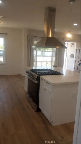 a kitchen with stainless steel appliances granite countertop a sink and a stove