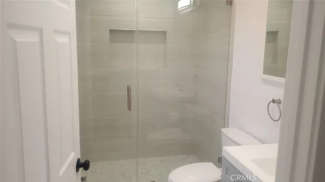 a bathroom with a shower and toilet