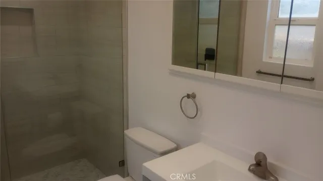 a bathroom with a toilet and a shower