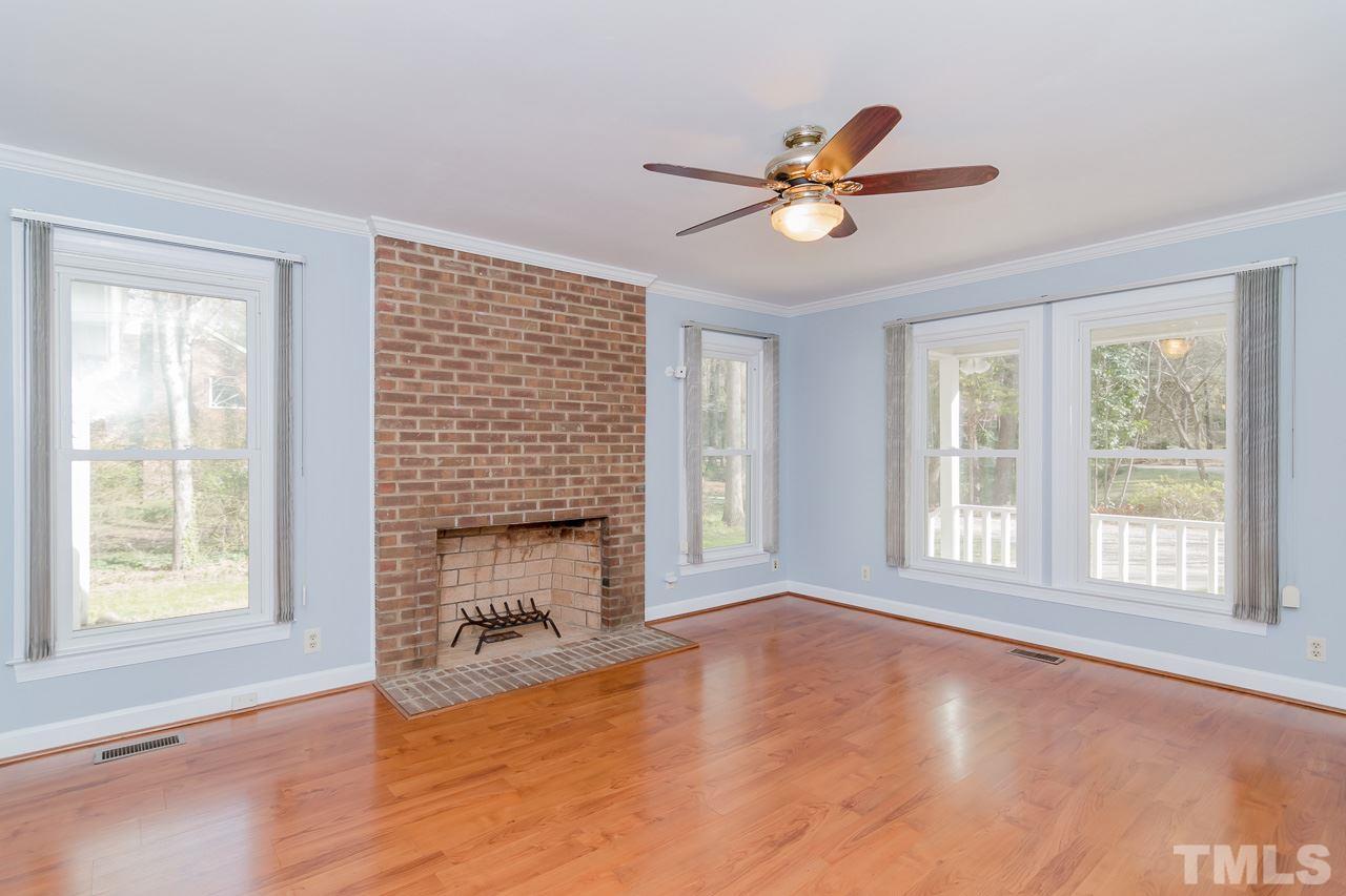 1404 Onslow Road Raleigh, NC 27606 - Photo 11 of 30 a view of livingroom with window fireplace and ceiling fan