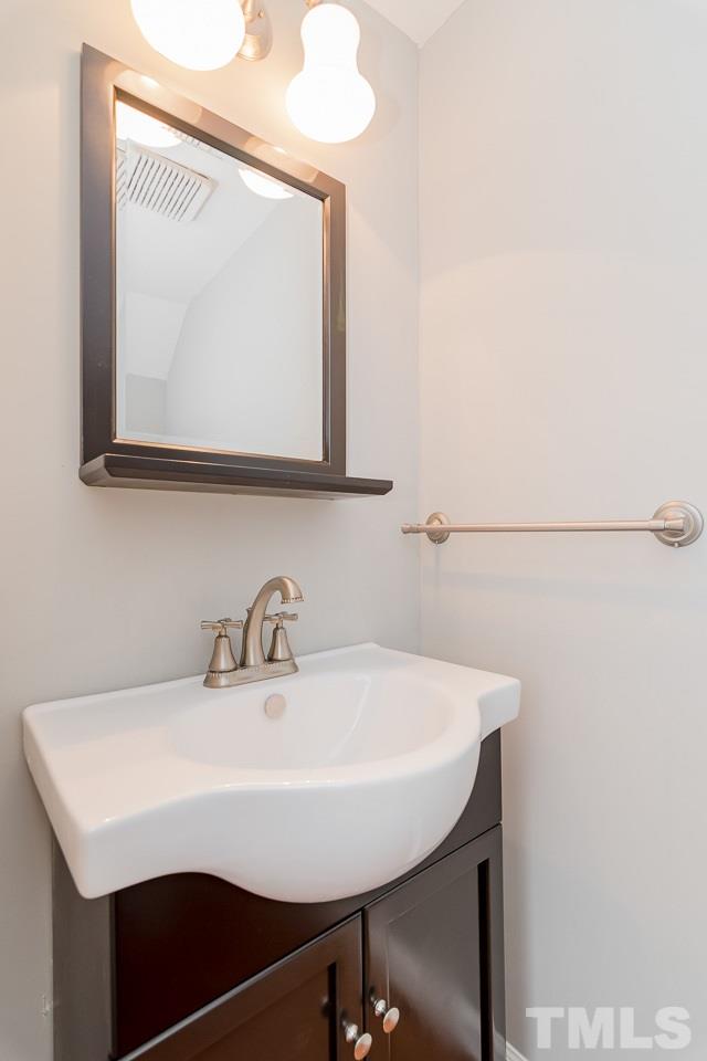 1404 Onslow Road Raleigh, NC 27606 - Photo 16 of 30 a bathroom with a sink a mirror and a toilet