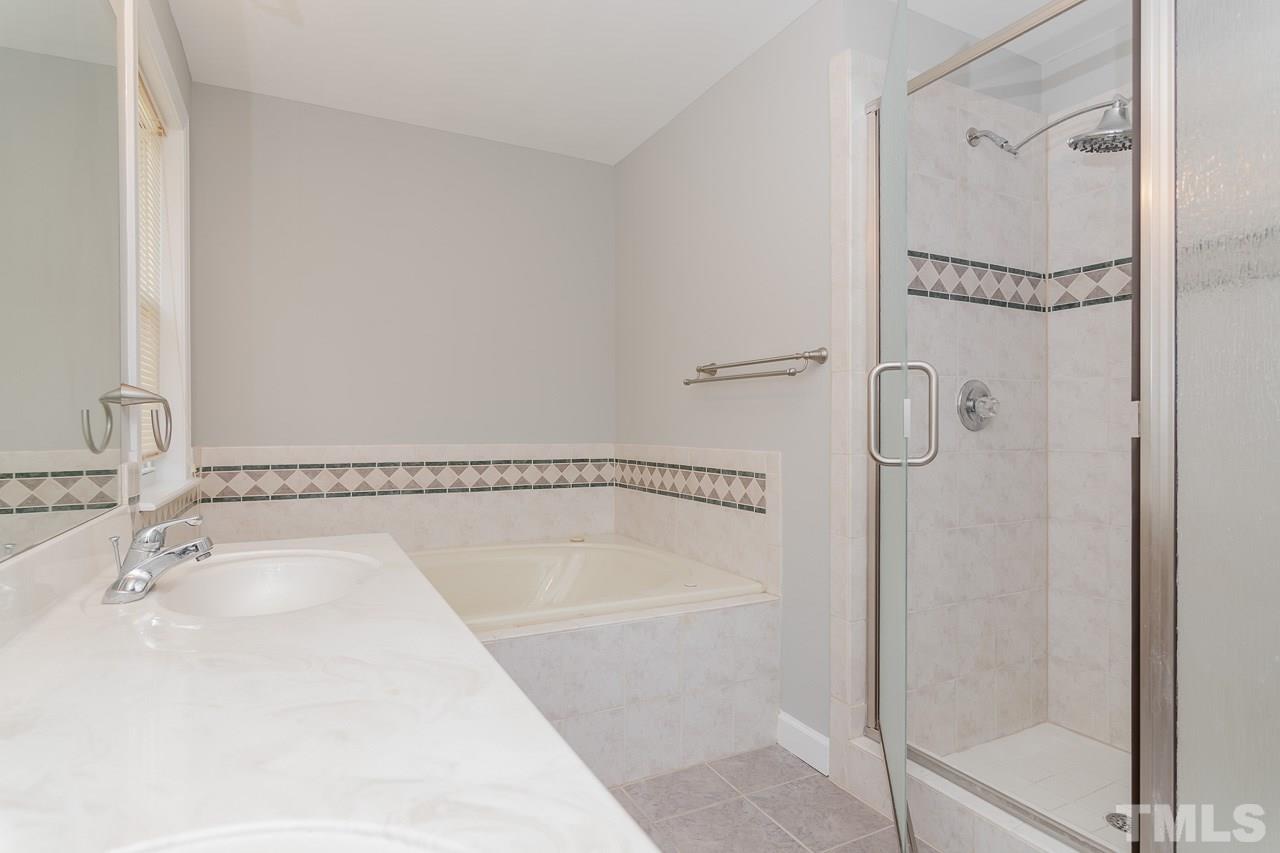 1404 Onslow Road Raleigh, NC 27606 - Photo 20 of 30 a bathroom with a tub shower vanity and a sink