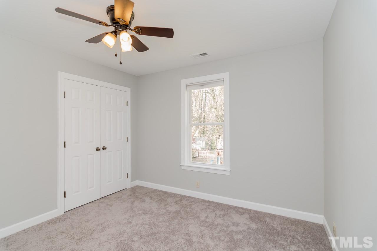 1404 Onslow Road Raleigh, NC 27606 - Photo 21 of 30 an empty room with windows and fan