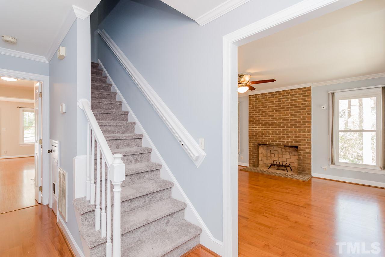 1404 Onslow Road Raleigh, NC 27606 - Photo 9 of 30 a view of a livingroom with wooden floor and stairs
