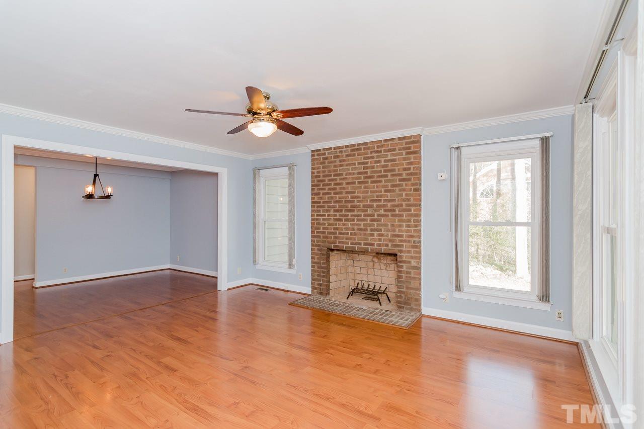 1404 Onslow Road Raleigh, NC 27606 - Photo 10 of 30 an empty room with windows and fireplace