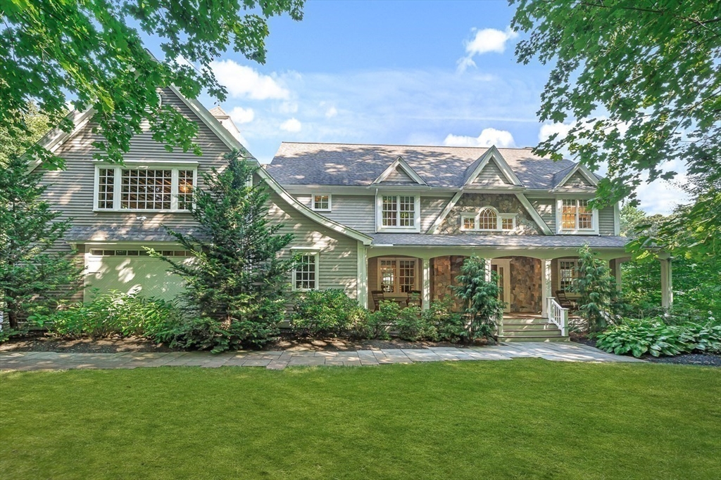 a front view of a house with a garden