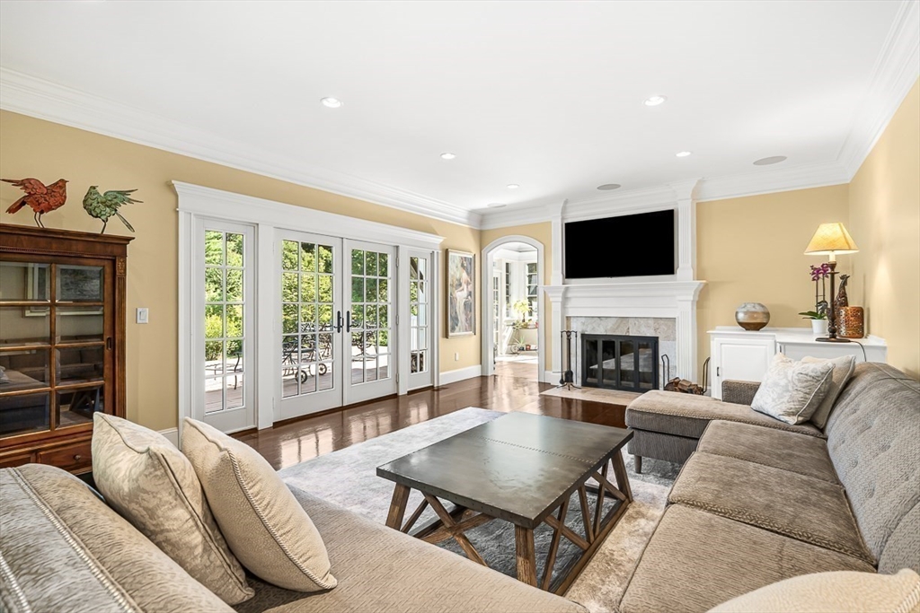 33 Old Concord Road Lincoln, MA 01773 - Photo 12 of 42 a living room with furniture a fireplace and a flat screen tv
