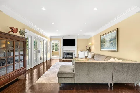 a living room with fireplace furniture and a flat screen tv