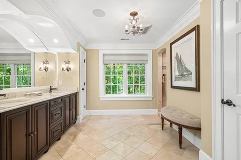 a spacious bathroom with a large tub sink and window