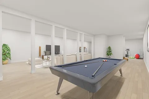 a living room with furniture pool table and chairs