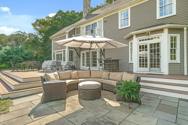 a view of a patio with couches table and chairs and potted plants