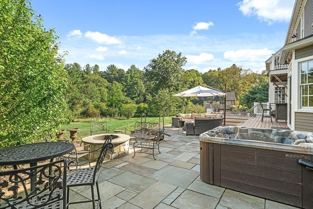 33 Old Concord Road Lincoln, MA 01773 - Photo 38 of 42 a view of a patio with table and chairs and potted plants