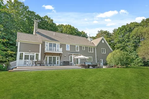 a front view of a house with a yard table and chairs