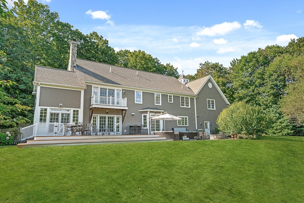 33 Old Concord Road Lincoln, MA 01773 - Photo 40 of 42 a front view of a house with a yard table and chairs