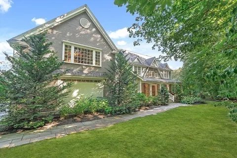 a front view of house with yard and green space