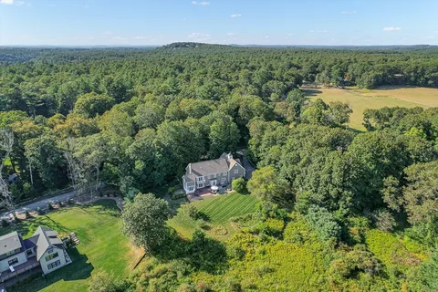an aerial view of a house with a yard