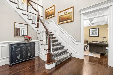 a view of entryway livingroom and hall with wooden floor