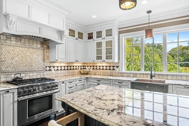 a kitchen with a stove a sink and a microwave