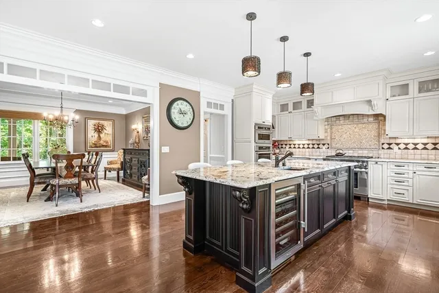 a kitchen with stainless steel appliances granite countertop a stove and cabinets