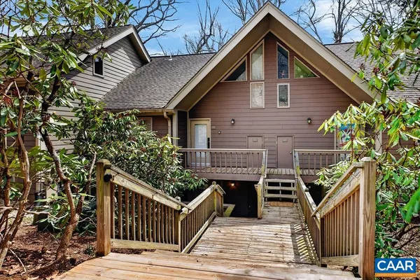 a view of a swimming pool with a patio and backyard