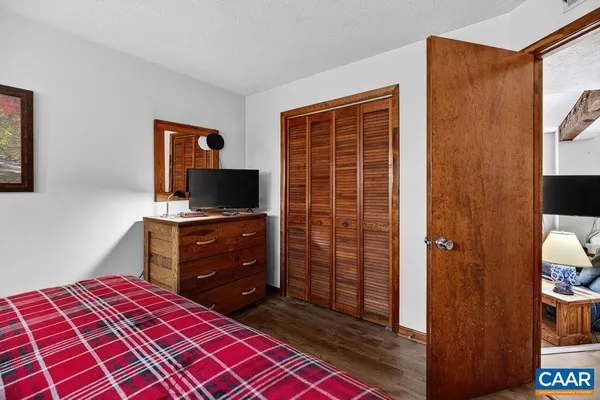 a bedroom with a bed and a television