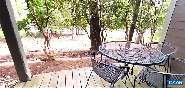 a view of a swimming pool with a patio and backyard