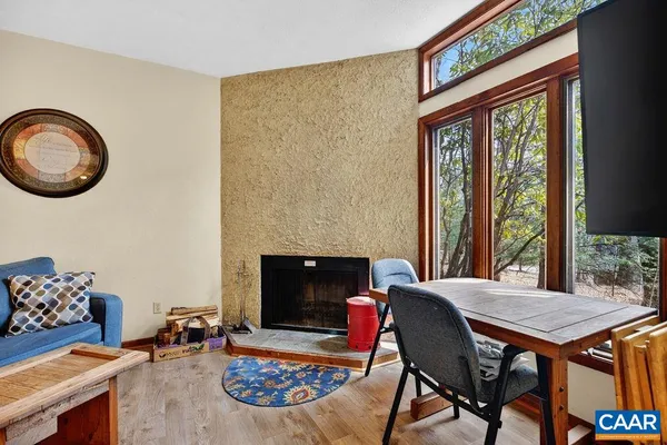 a living room with furniture a table and a fireplace