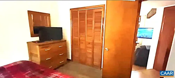 a view of a kitchen with refrigerator and mirror