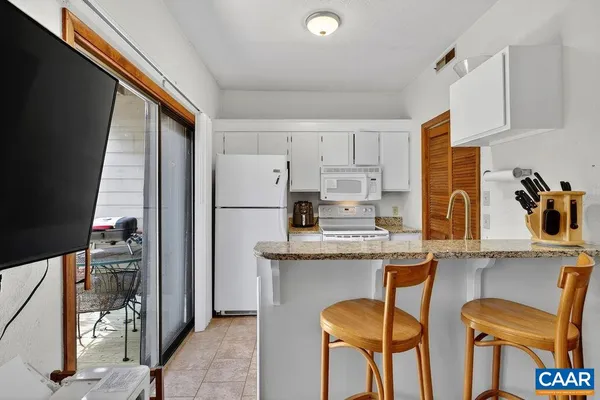 a kitchen with stainless steel appliances granite countertop a refrigerator and cabinets