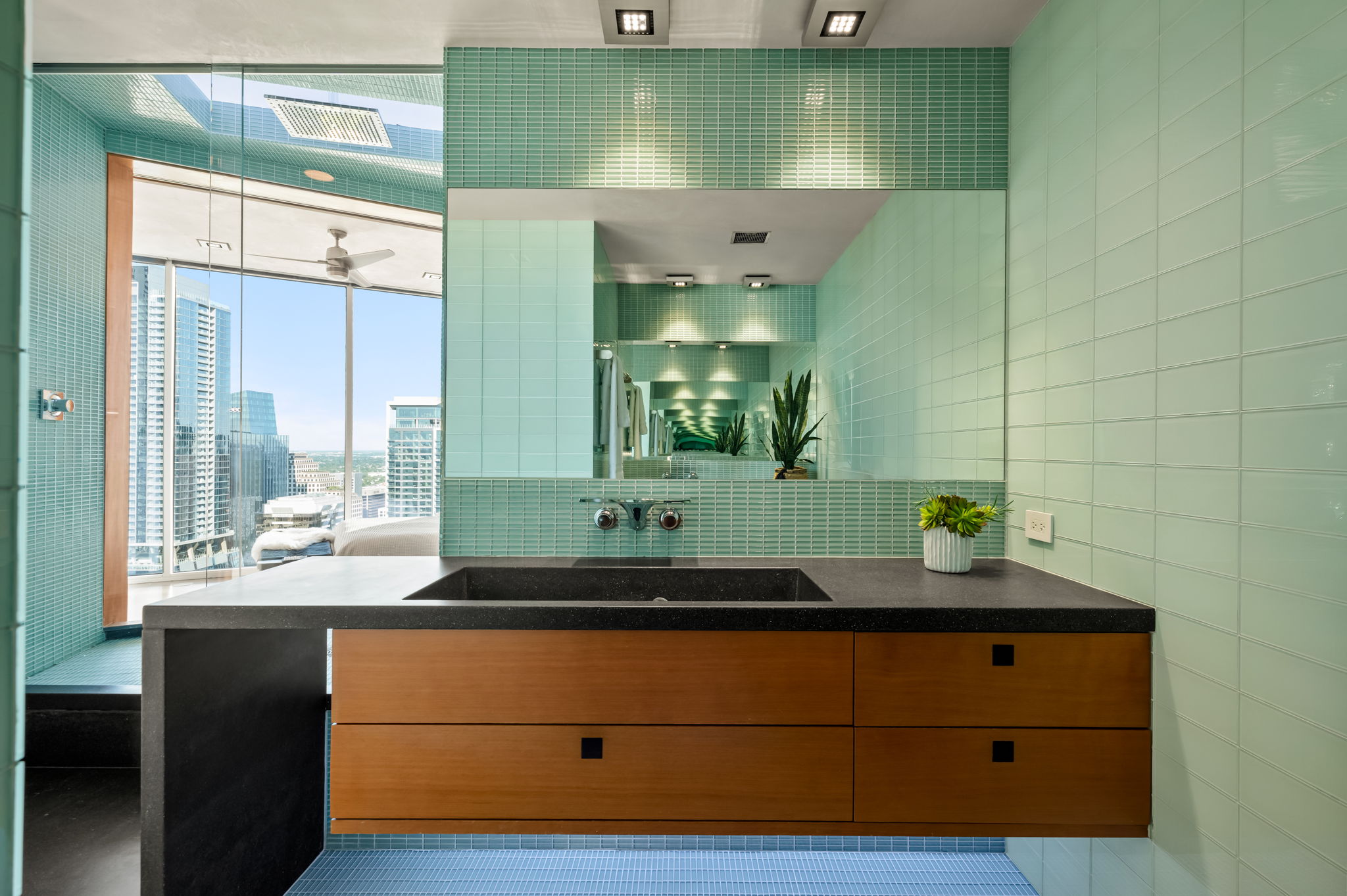360 Nueces Street, Unit 4211 Austin, TX 78701 - Photo 33 of 40 a bathroom with a sink and a mirror