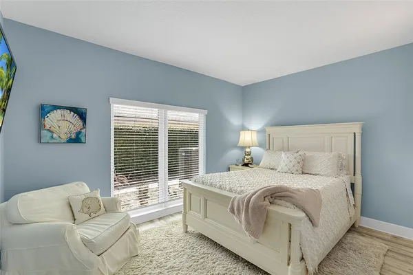 a bedroom with a bed and a couch with outer view