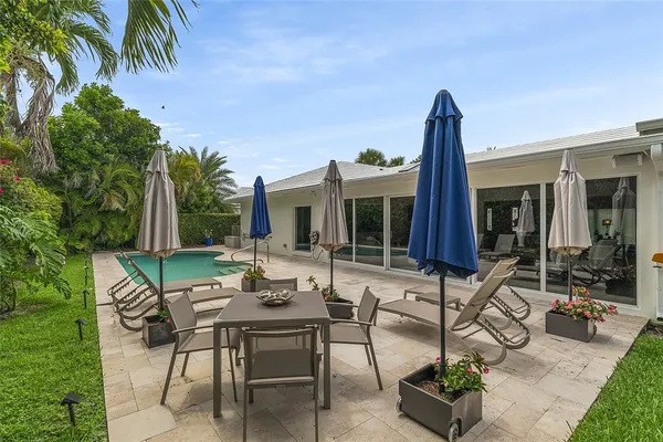 a view of a house with backyard sitting area and garden