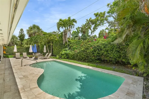 a view of a swimming pool with a sitting area