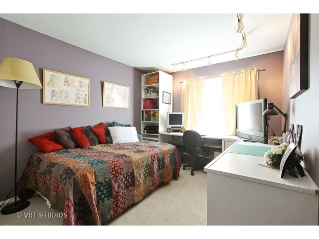 492 Rustic Drive, Unit 492 Wheeling, IL 60090 - Photo 12 of 20 a bedroom with a bed and a flat tv screen on dresser