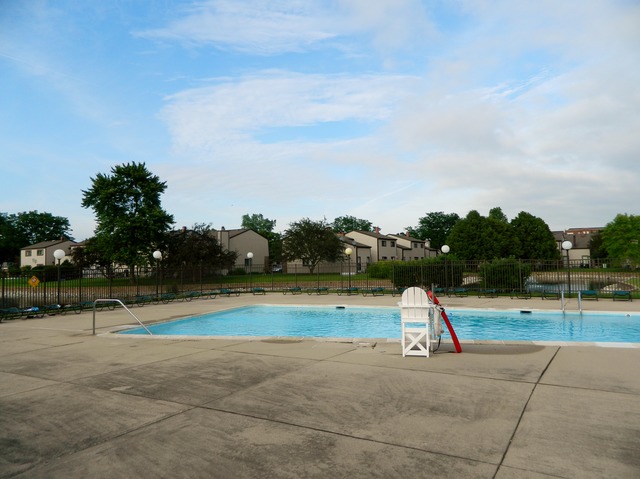 492 Rustic Drive, Unit 492 Wheeling, IL 60090 - Photo 20 of 20 a view of a swimming pool with an outdoor space and seating area
